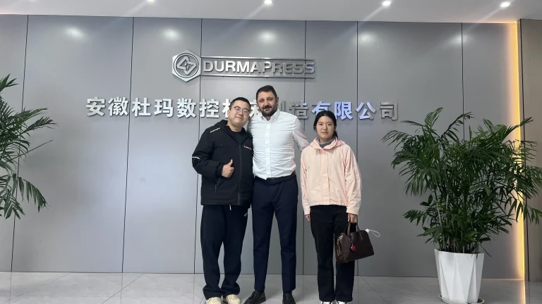 Turkish client and Durmapress staff standing at factory entrance