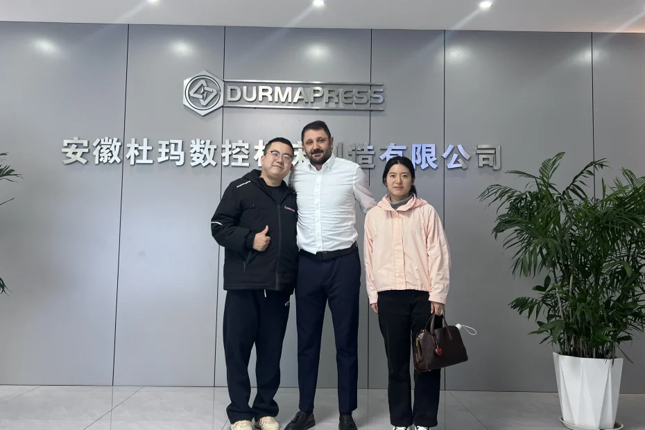 Turkish client and Durmapress staff standing at factory entrance