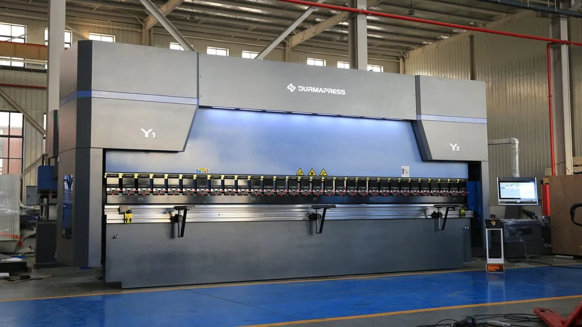 CNC press brake forming sheet metal in a manufacturing workshop