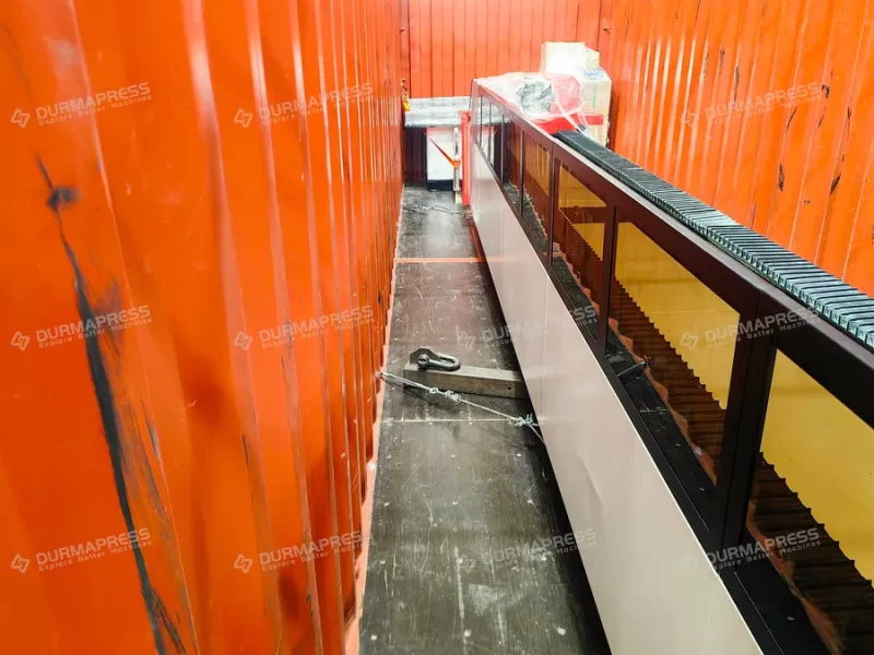 Laser cutting machine secured with anti-vibration pads inside container