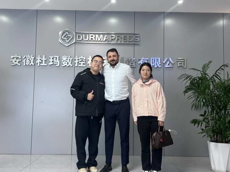 Turkish client and Durmapress staff standing at factory entrance